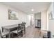 Dining area featuring a gray table set, neutral walls, and easy access to additional rooms in the house at 7015 N Dakota Ave, Tampa, FL 33604
