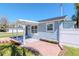 Cozy single-story home with covered porch, flower boxes, and a white picket fence at 7015 N Dakota Ave, Tampa, FL 33604