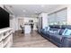 Open-concept living space with modern kitchen, cozy living room, and stylish gray flooring at 7015 N Dakota Ave, Tampa, FL 33604
