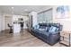 Open-concept living space with modern kitchen, cozy living room, and stylish gray flooring at 7015 N Dakota Ave, Tampa, FL 33604