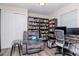Functional office with a cozy recliner, extensive bookshelves, and a well-equipped workspace for productivity at 7015 N Dakota Ave, Tampa, FL 33604