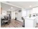 Spacious open floorplan with updated flooring, connecting the living area, dining space, and modern kitchen at 7015 N Dakota Ave, Tampa, FL 33604