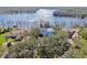 Aerial view showcasing a home with lake access, lush trees and mature landscaping at 8510 Lays Cove Pl, Odessa, FL 33556