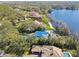 Aerial of lakefront homes, mature trees, and sparkling lake, offering a serene setting at 8510 Lays Cove Pl, Odessa, FL 33556