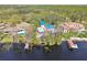 Beautiful waterfront homes with lush landscaping and private docks on a sunny day at 8510 Lays Cove Pl, Odessa, FL 33556