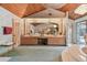 Large bathroom featuring a wood-paneled ceiling, ample counter space, and a door to the outside at 8510 Lays Cove Pl, Odessa, FL 33556