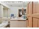 Bathroom featuring a Keurig, neutral colored cabinetry and an ensuite bathroom at 8510 Lays Cove Pl, Odessa, FL 33556