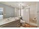 Bathroom featuring a spacious vanity with built-in lighting and a shower area at 8510 Lays Cove Pl, Odessa, FL 33556