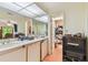 Functional bathroom with a double sink vanity, ample counter space, and plenty of mirrors at 8510 Lays Cove Pl, Odessa, FL 33556