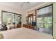 Bedroom with a private screened patio, allowing seamless indoor-outdoor living and tranquil retreat at 8510 Lays Cove Pl, Odessa, FL 33556