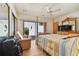 Bright bedroom with a four-poster bed, sliding glass door, and comfortable seating at 8510 Lays Cove Pl, Odessa, FL 33556