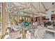 Bright dining area with glass table and comfortable chairs surrounded by windows with views of nature at 8510 Lays Cove Pl, Odessa, FL 33556