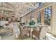 Inviting dining area boasts ample natural light from surrounding windows, open to the living room at 8510 Lays Cove Pl, Odessa, FL 33556