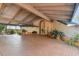 Expansive, covered driveway featuring patterned brickwork and mature potted plants at 8510 Lays Cove Pl, Odessa, FL 33556