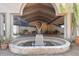 Inviting entrance with grand fountain and covered portico featuring detailed stonework at 8510 Lays Cove Pl, Odessa, FL 33556