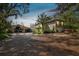 Exterior of home featuring a unique driveway, covered entry, and mature landscaping at 8510 Lays Cove Pl, Odessa, FL 33556