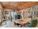 Cozy home office with wood-paneled ceiling, natural light, and walls adorned with pictures and decor at 8510 Lays Cove Pl, Odessa, FL 33556