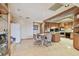 Bright eat in kitchen featuring a kitchen island, tile flooring, wood cabinets, and modern appliances at 8510 Lays Cove Pl, Odessa, FL 33556