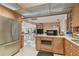 Cozy kitchen with stainless steel refrigerator and adjacent dining and seating area at 8510 Lays Cove Pl, Odessa, FL 33556