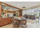 Bright kitchen featuring wooden cabinetry, kitchen table and chairs, and open floor plan to dining area at 8510 Lays Cove Pl, Odessa, FL 33556