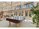 Bright, sunlit Gathering room featuring vaulted ceilings, floor-to-ceiling windows, and an elegant ping pong table at 8510 Lays Cove Pl, Odessa, FL 33556