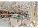 Bright living room area featuring vaulted ceilings, track lighting, and a glass table set for comfortable seating at 8510 Lays Cove Pl, Odessa, FL 33556