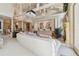 Bright living room features a large white sofa, fireplace and vaulted ceilings with exposed beams at 8510 Lays Cove Pl, Odessa, FL 33556