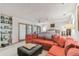 Bright main bedroom with a large sectional, ceiling fan, and access to a private outdoor space at 8510 Lays Cove Pl, Odessa, FL 33556