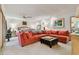 Spacious main bedroom featuring a large sectional sofa, a ceiling fan, and neutral carpeting at 8510 Lays Cove Pl, Odessa, FL 33556