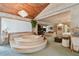 Spacious main bedroom with wood paneled ceiling, chandelier, step-up tub, seating area, and closet at 8510 Lays Cove Pl, Odessa, FL 33556