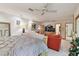 Large bedroom with a ceiling fan, sitting area, and access to an ensuite bathroom at 8510 Lays Cove Pl, Odessa, FL 33556