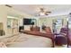 Spacious main bedroom with a view, seating area, TV, and neutral colors promotes tranquility at 8510 Lays Cove Pl, Odessa, FL 33556