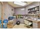 Home office with light pink walls, built-in shelving, work space, and tile floors at 8510 Lays Cove Pl, Odessa, FL 33556