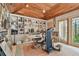 Bright office space with a wood paneled ceiling, extensive built-in shelving, and outdoor access at 8510 Lays Cove Pl, Odessa, FL 33556