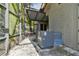 View of the side patio, with an outdoor AC unit, a screened enclosure, and a stucco wall at 8510 Lays Cove Pl, Odessa, FL 33556