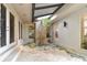 Charming covered patio featuring tiled flooring, potted plants and multiple doors leading to the house at 8510 Lays Cove Pl, Odessa, FL 33556