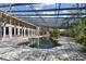 View of the indoor pool inside a unique atrium with tile flooring and metal supports at 8510 Lays Cove Pl, Odessa, FL 33556