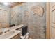 Unique powder room with textured wallpaper, vintage fixtures, and decorative fans at 8510 Lays Cove Pl, Odessa, FL 33556