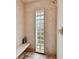 Modern shower stall with neutral tile, glass block window, a built-in bench, and sleek fixtures at 8510 Lays Cove Pl, Odessa, FL 33556