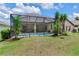 Well-maintained backyard features a screened-in pool area, lush landscaping, and ample space for outdoor enjoyment at 12906 Tar Flower Dr, Tampa, FL 33626