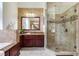 Elegant bathroom with granite counters, a glass shower and brick accent wall at 12906 Tar Flower Dr, Tampa, FL 33626