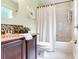 Bathroom features vanity with a granite countertop and a shower-tub combo at 12906 Tar Flower Dr, Tampa, FL 33626