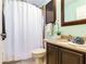 Cozy bathroom featuring shower with curtain, vanity and tile flooring at 12906 Tar Flower Dr, Tampa, FL 33626