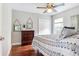 Bright bedroom with hardwood floors, ceiling fan and decorative chest of drawers at 12906 Tar Flower Dr, Tampa, FL 33626
