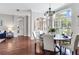 Dining area features hardwood floors, chandelier lighting, and access to the living room at 12906 Tar Flower Dr, Tampa, FL 33626