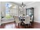 Formal dining area with a round table, chandelier lighting, and large window at 12906 Tar Flower Dr, Tampa, FL 33626