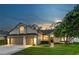 Charming single-Gathering home featuring a well-manicured lawn and a two-car garage against a picturesque evening sky at 12906 Tar Flower Dr, Tampa, FL 33626