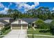 Well-maintained single-Gathering home with a three-car garage and beautiful landscaping at 12906 Tar Flower Dr, Tampa, FL 33626