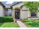 Charming front porch with decorative plants, a welcoming sign, and a well-maintained walkway at 12906 Tar Flower Dr, Tampa, FL 33626