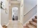 Welcoming hallway leading to staircase with carpet and tile flooring at 12906 Tar Flower Dr, Tampa, FL 33626